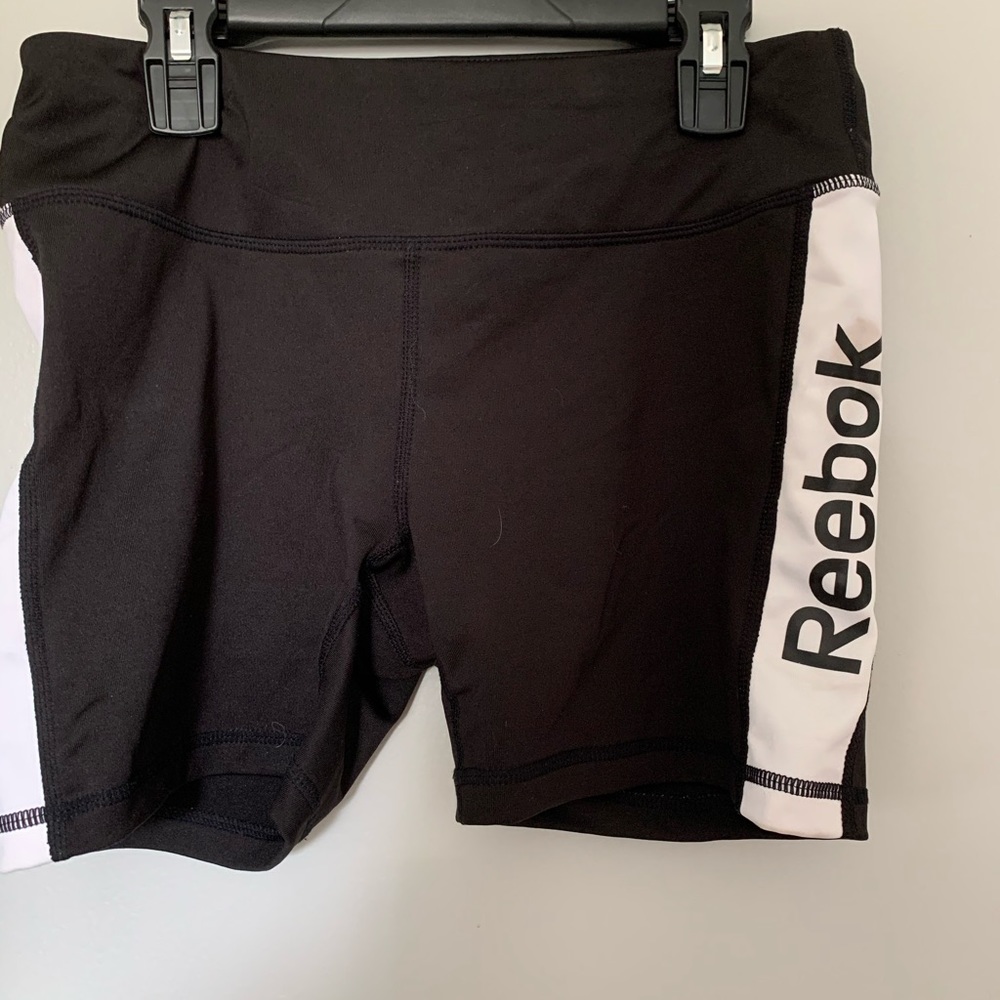 Reebok spandex shorts with logo and white stripes